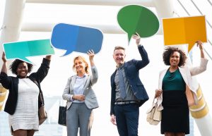 4 persons holding up thought signs
