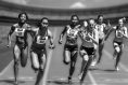 women in a relay race, passing batons